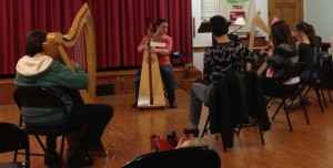 Harper Angela Biggs teaches the beginner harp workshop.