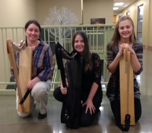 Harp Instructor Angela Biggs with students from the Hands On Harps workshop. In the Background, wire tree sculpture by WCCMA's Opus Arts Group artist Randy Adams.